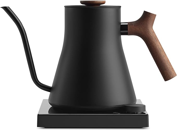 Fellow Stagg EKG Pro Studio kettle in matte black with walnut handle on counter