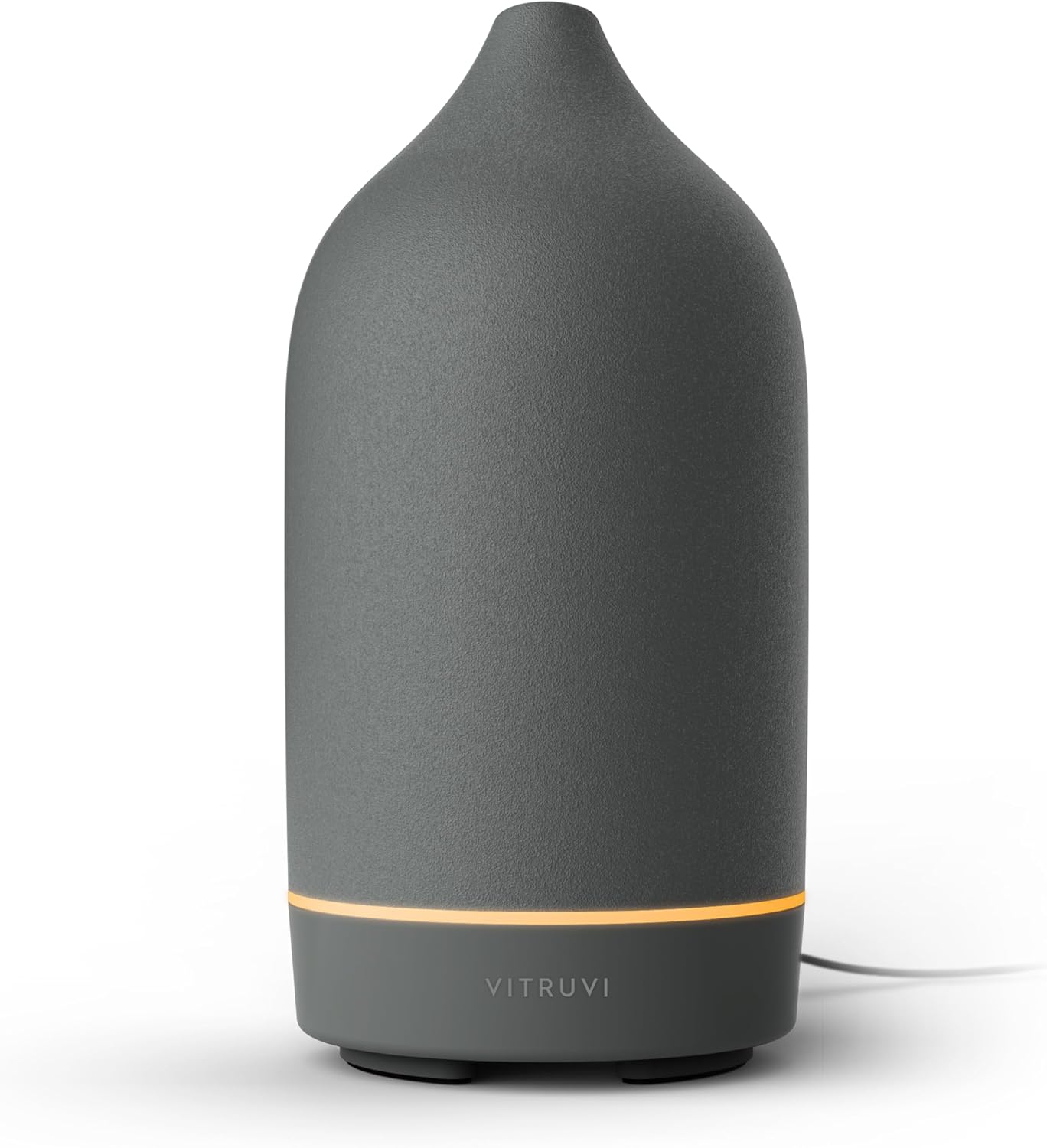 Vitruvi Move diffuser on a cozy home coffee table with blankets