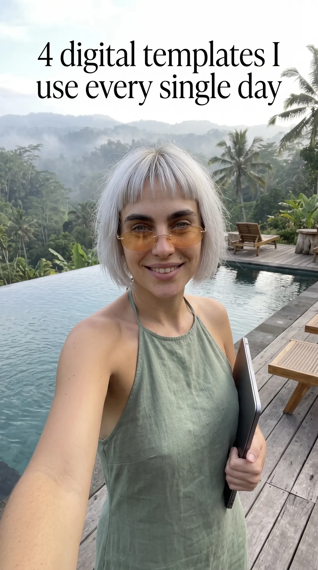 Kaia in a sage halter top taking a selfie by an infinity pool over a jungle, holding a tablet with the ADHD Digital Planner