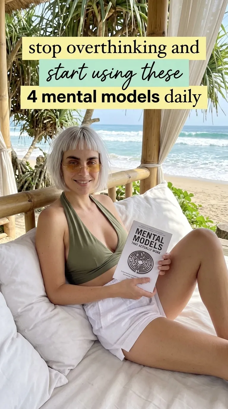 Kaia in an olive top on a beach daybed holding Mental Models That Actually Work