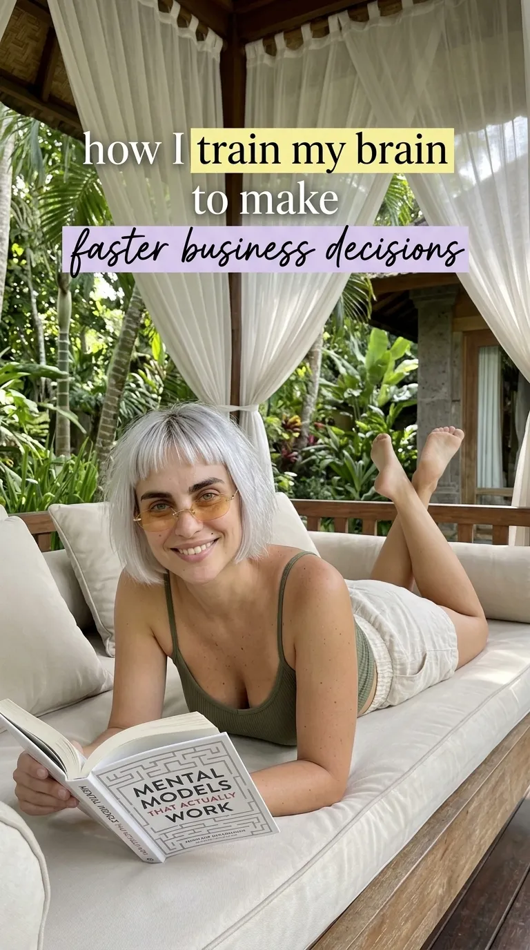 Kaia in an olive top lying on a canopy daybed reading Mental Models That Actually Work