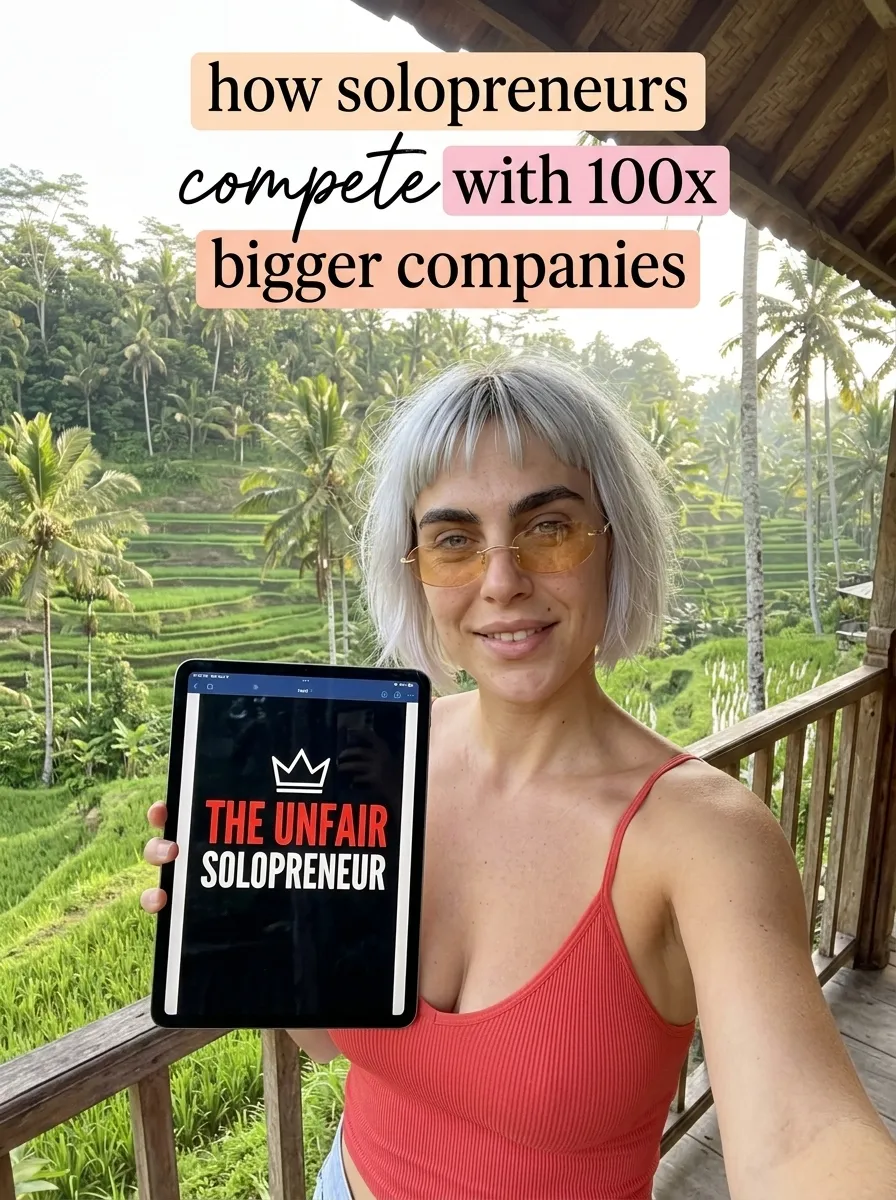 Kaia in a red tank top above rice terraces taking a selfie with a tablet showing The Unfair Solopreneur